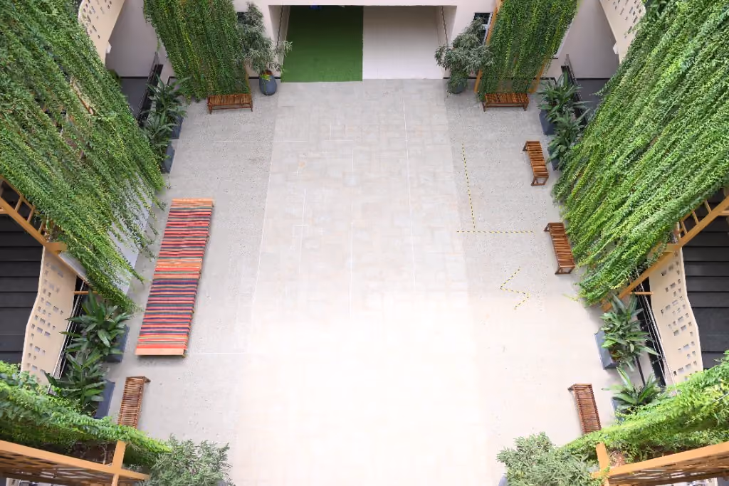 School courtyard with hanging gardens, planters, and open learning space