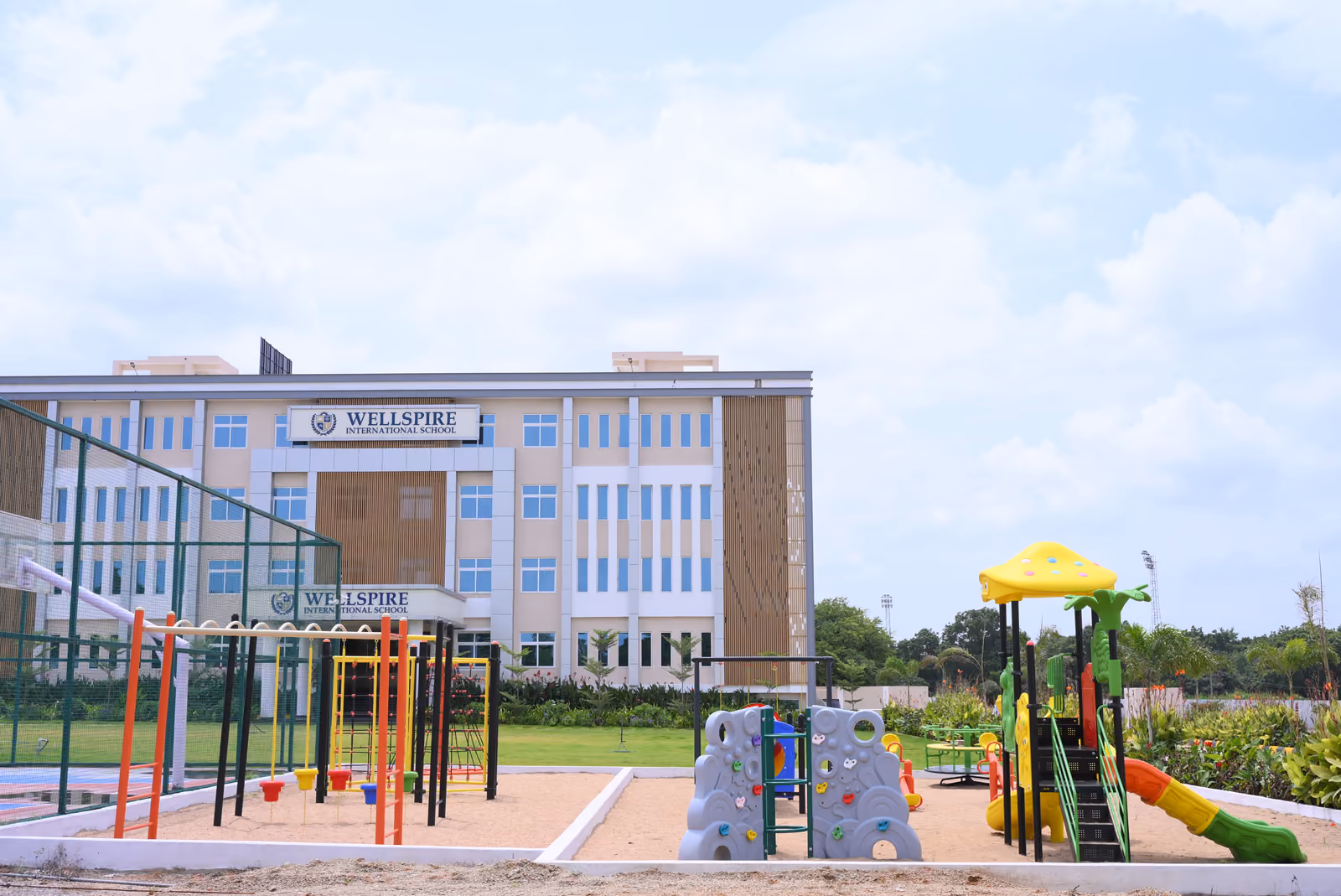 Outdoor playground and climbing frames beside the school building